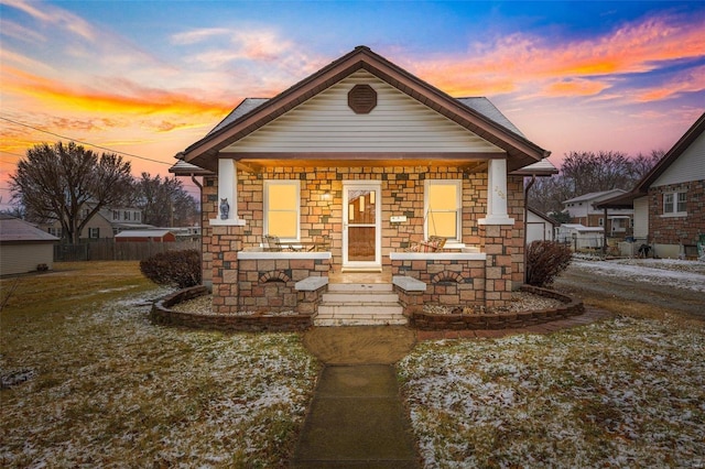 bungalow-style home with a lawn