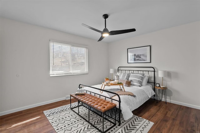 bedroom with a ceiling fan, baseboards, and wood finished floors