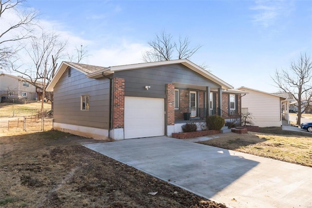 ranch-style house featuring brick siding, a porch, an attached garage, fence, and driveway