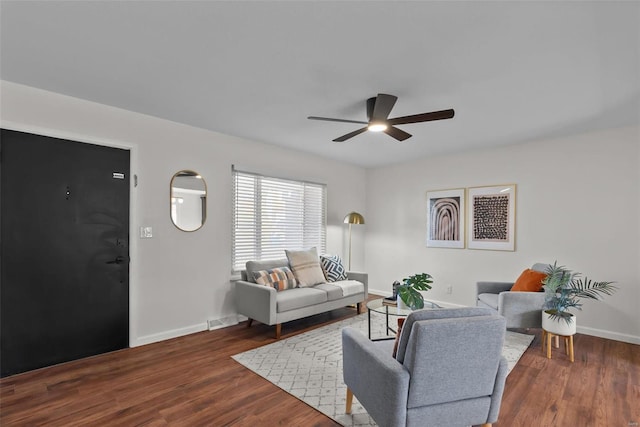 living room with a ceiling fan, wood finished floors, visible vents, and baseboards