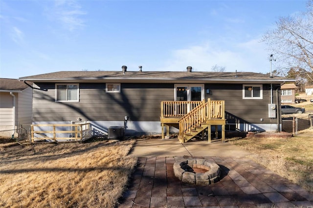 back of house with a patio, an outdoor fire pit, central AC unit, fence, and a wooden deck