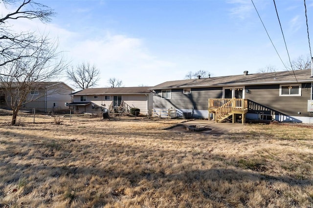 rear view of house featuring fence