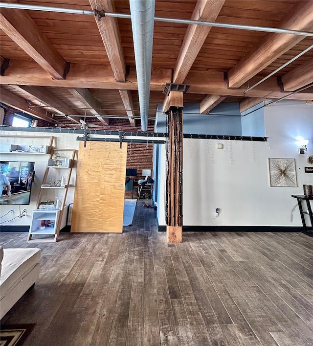 basement with wood ceiling, dark wood-type flooring, and a barn door