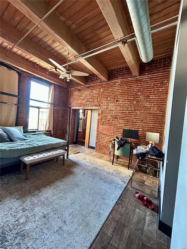 bedroom featuring hardwood / wood-style flooring, brick wall, beam ceiling, and wooden ceiling