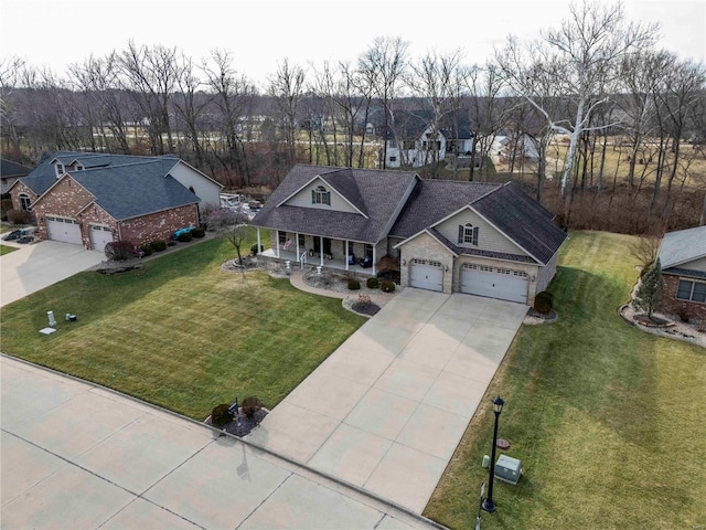 view of front of property featuring a garage, covered porch, and a front yard