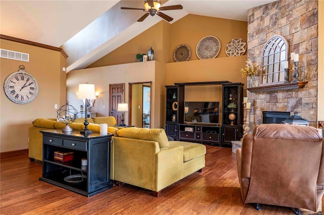 living room with a fireplace, wood-type flooring, high vaulted ceiling, and ceiling fan