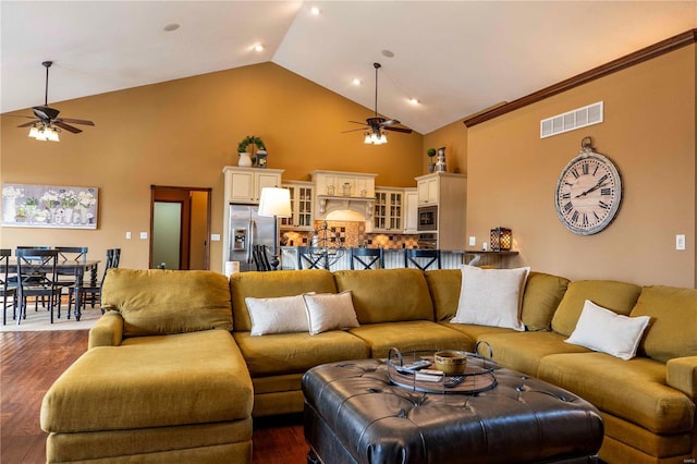 living room featuring dark wood-type flooring, ceiling fan, and high vaulted ceiling