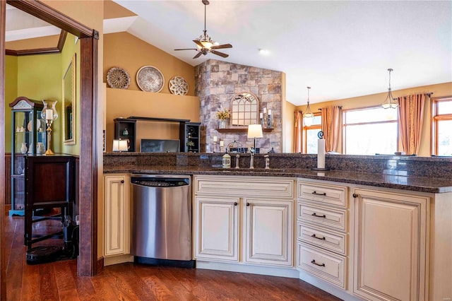 kitchen featuring dark wood-type flooring, vaulted ceiling, dark stone countertops, dishwasher, and pendant lighting