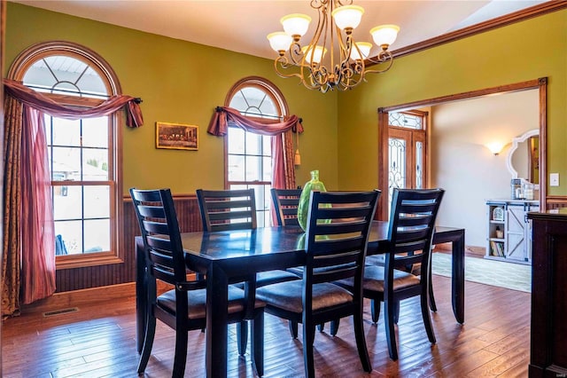 dining area featuring a chandelier and hardwood / wood-style floors