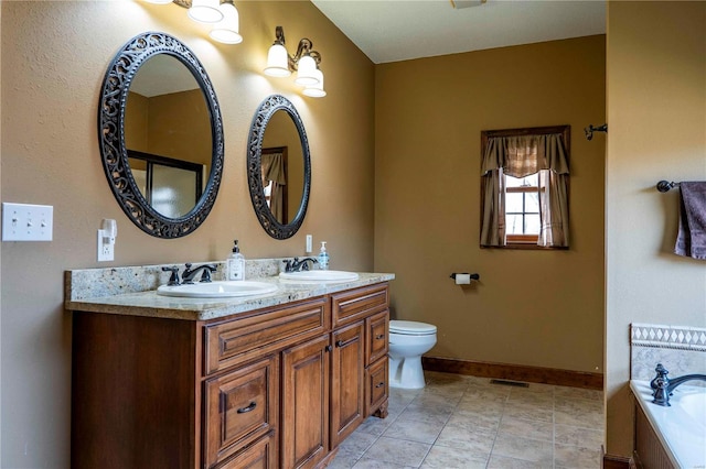 bathroom with vanity, toilet, tile patterned flooring, and a tub