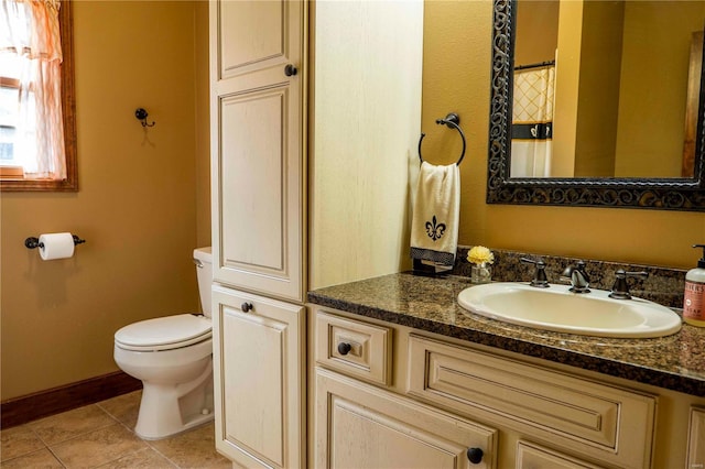 bathroom featuring tile patterned flooring, vanity, and toilet