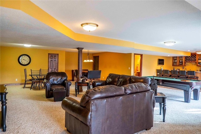 living room featuring light colored carpet, bar area, decorative columns, and pool table