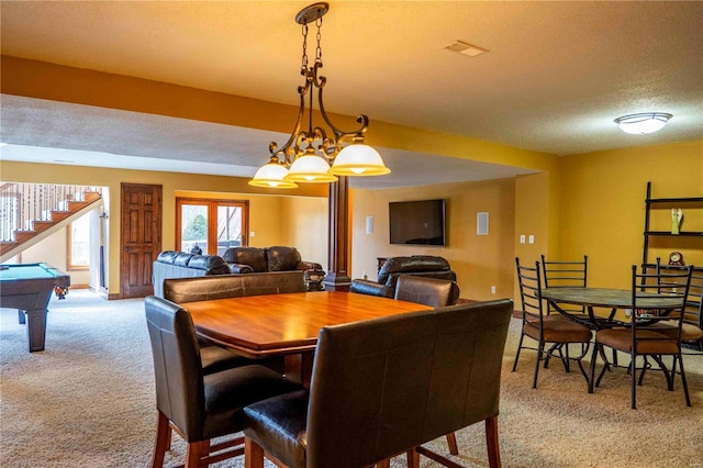 dining area with billiards, light colored carpet, and a textured ceiling