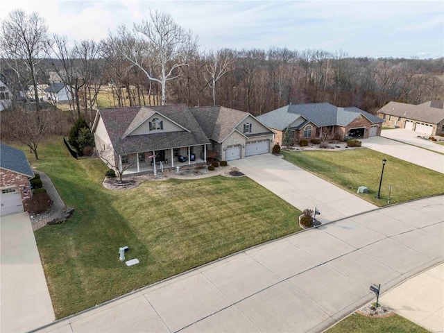 view of front facade with a garage, a porch, and a front lawn