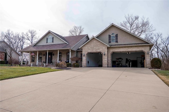 view of front facade with a porch, a garage, and a front lawn