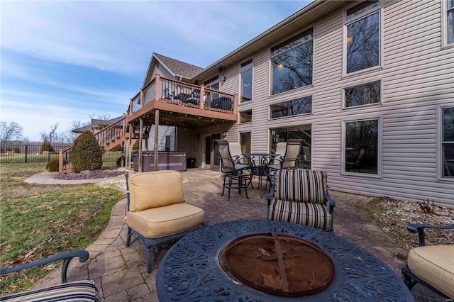 view of patio / terrace featuring a deck and an outdoor fire pit