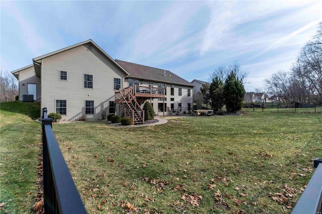 rear view of property with central AC, a deck, and a lawn