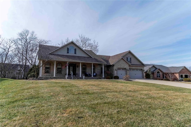 view of front of property with a garage, a front lawn, and a porch