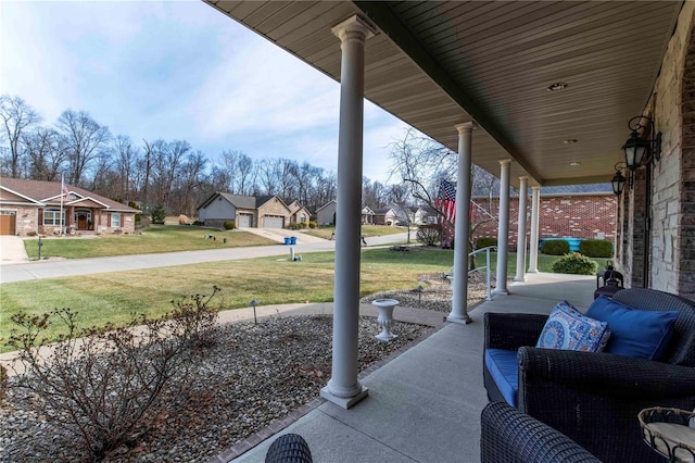 view of patio / terrace with a porch and a garage