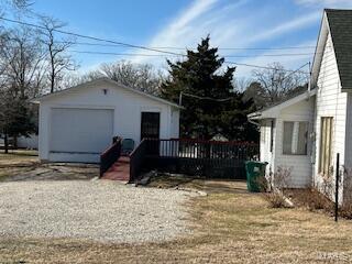 exterior space with a garage, an outdoor structure, and a deck