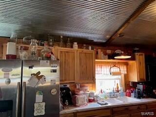 kitchen featuring stainless steel fridge with ice dispenser