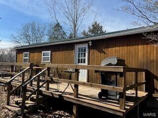 back of house with a wooden deck