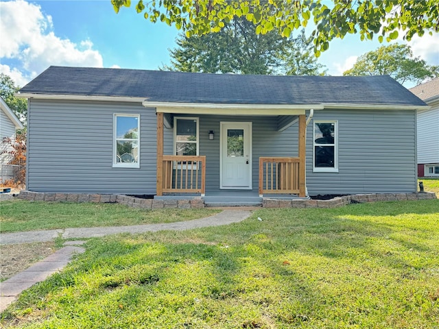 view of front of house with a front yard and a porch