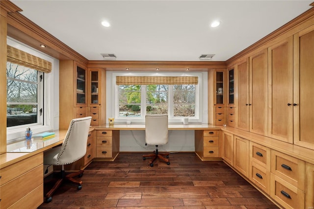 office area featuring dark wood-type flooring, built in study area, and a healthy amount of sunlight