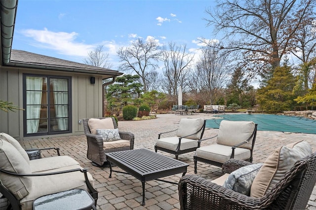 view of patio / terrace with outdoor lounge area and a covered pool