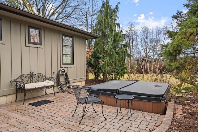 view of patio / terrace featuring fence and a hot tub