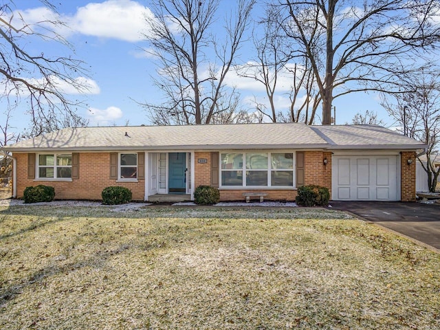 single story home featuring a garage and a front lawn