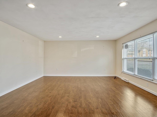 unfurnished room with hardwood / wood-style flooring