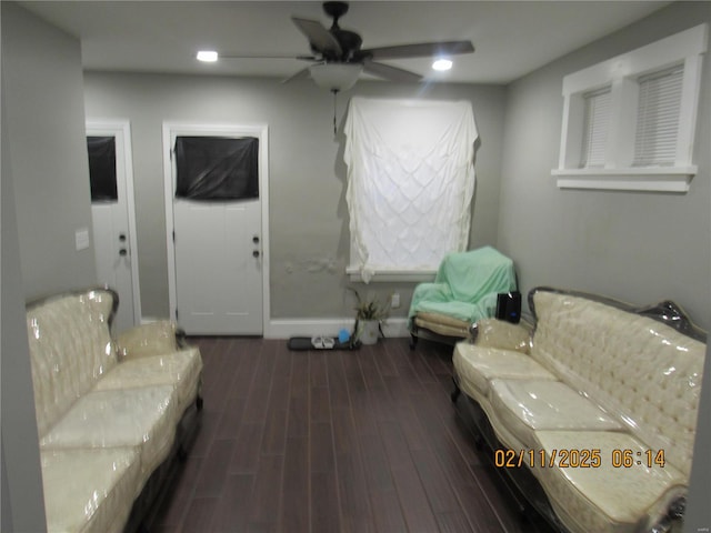 sitting room with ceiling fan and dark hardwood / wood-style flooring