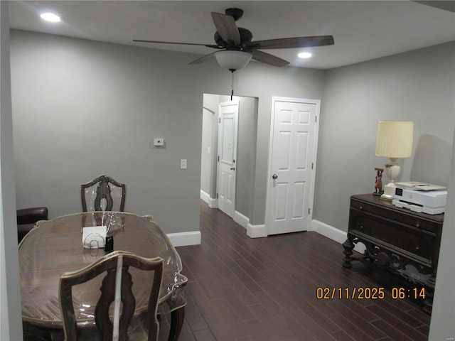 dining room with dark hardwood / wood-style flooring and ceiling fan