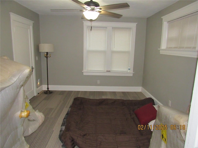 bedroom with ceiling fan and hardwood / wood-style floors