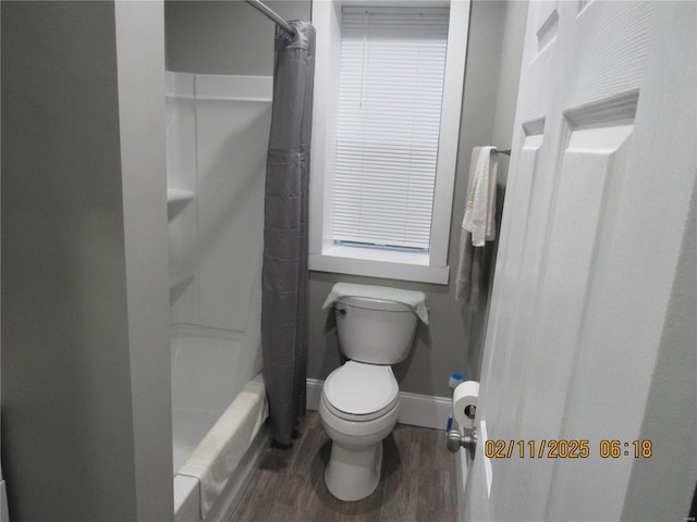 bathroom with wood-type flooring, shower / bath combo with shower curtain, and toilet