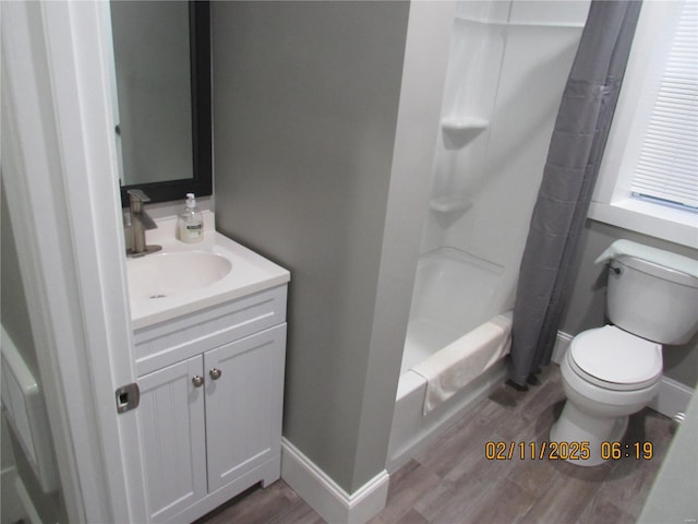 full bathroom featuring hardwood / wood-style flooring, shower / tub combo with curtain, vanity, and toilet