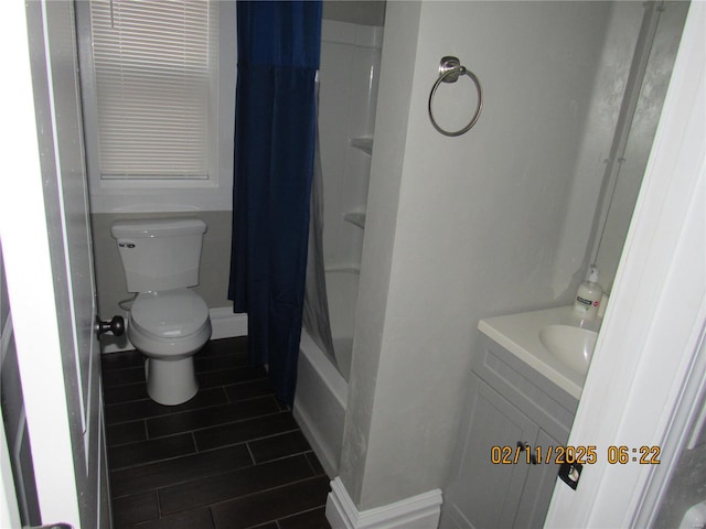 full bathroom featuring shower / bath combination with curtain, vanity, and toilet