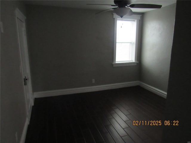 empty room featuring dark hardwood / wood-style floors and ceiling fan