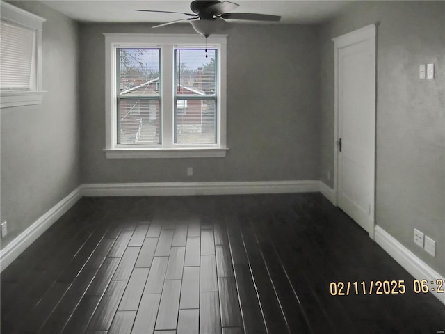 empty room featuring ceiling fan and dark hardwood / wood-style floors