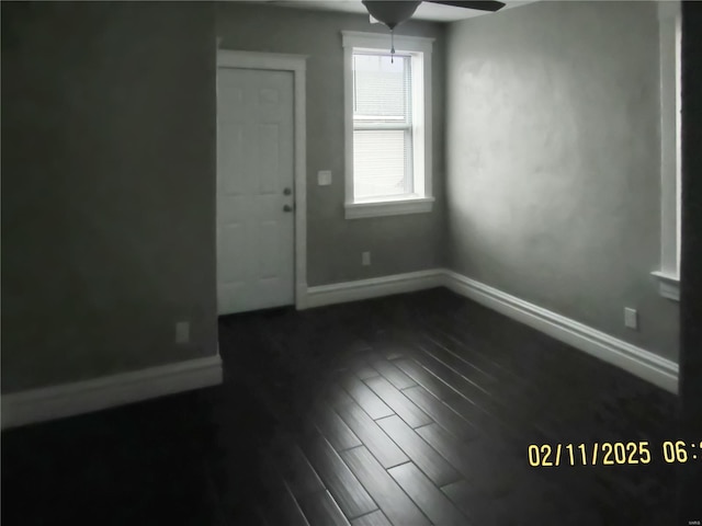 unfurnished room featuring ceiling fan and dark hardwood / wood-style flooring