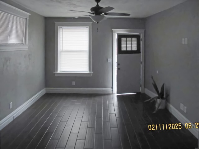 entryway with dark wood-type flooring and ceiling fan