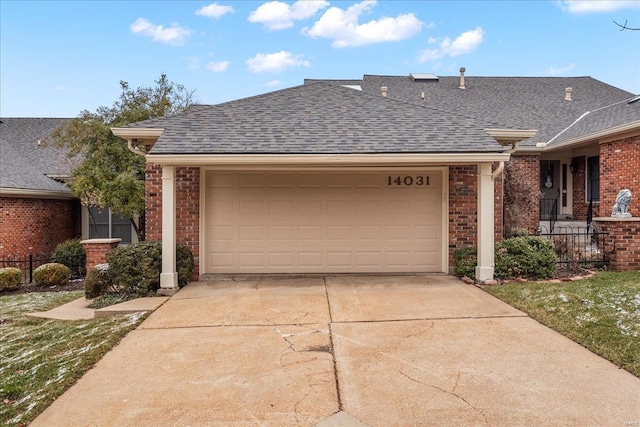 ranch-style home with brick siding, an attached garage, driveway, and roof with shingles