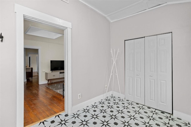 bedroom with crown molding and a closet