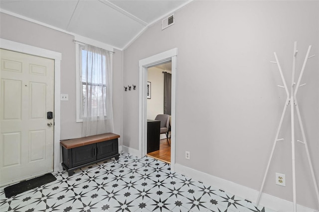 entrance foyer featuring crown molding and vaulted ceiling