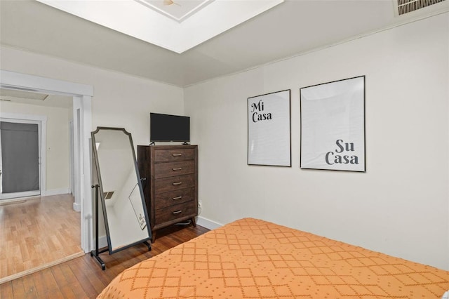 bedroom with dark wood-type flooring