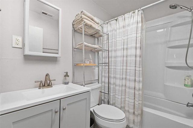 full bathroom featuring shower / tub combo with curtain, vanity, and toilet