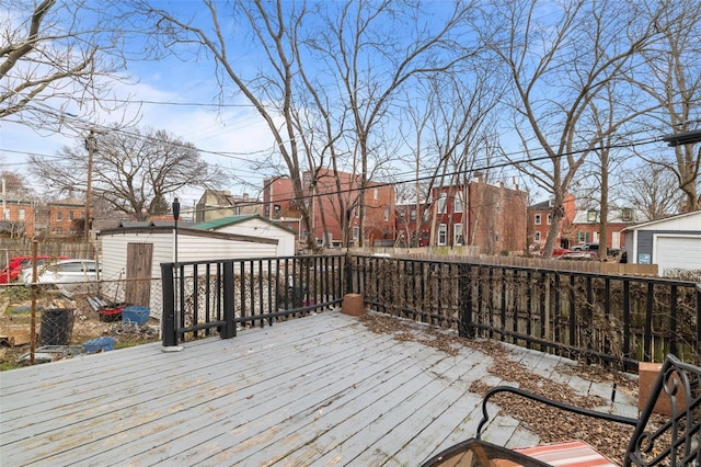 wooden terrace with a garage and an outbuilding