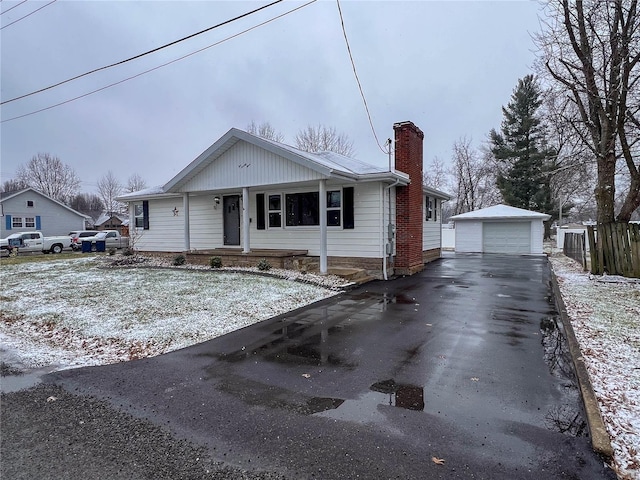 view of front of house with a garage, a porch, and an outbuilding