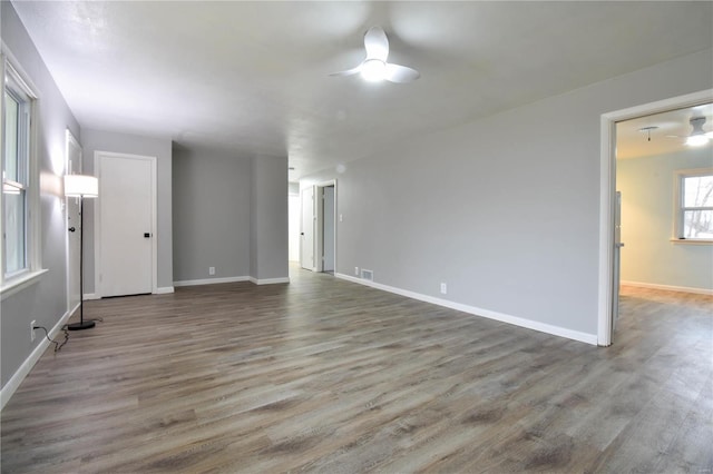 unfurnished room featuring ceiling fan and hardwood / wood-style floors